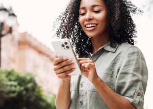 Woman walking while looking at phone.